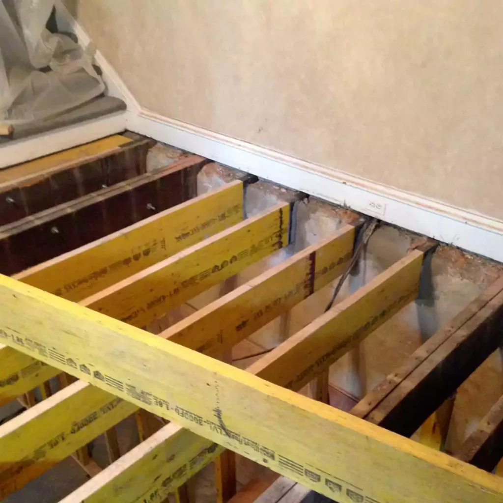 Wood beams being built for floor below staircase